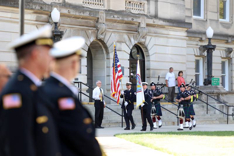 Attendees stand for the posting of the colors during the 44th Kankakee County Fallen Firefighter Memorial Service on Friday, Oct. 3, 2025.