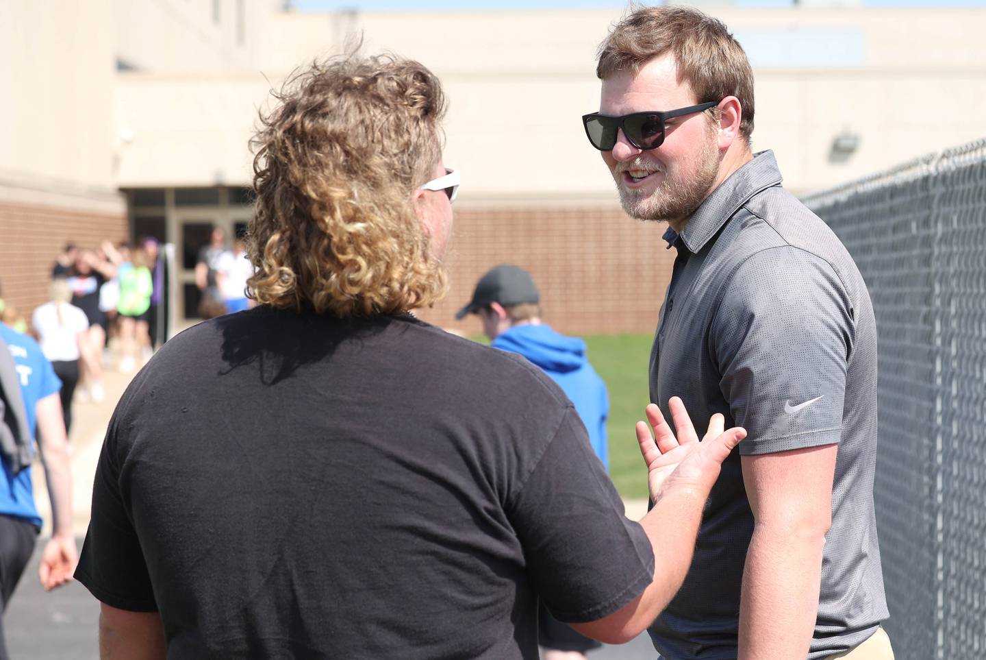 Griffin McNeal, Genoa-Kingston High School physical education teacher, talks to a student in his class Thursday, April 13, 2023, at the school.