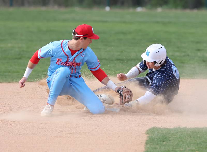 Nazareth's Jaden Fauske (21) tags second base as Benet's Luke Bafia (11) applies a tag during the varsity baseball game between Benet Academy and Nazareth Academy in La Grange Park on Monday, April 24, 2023.