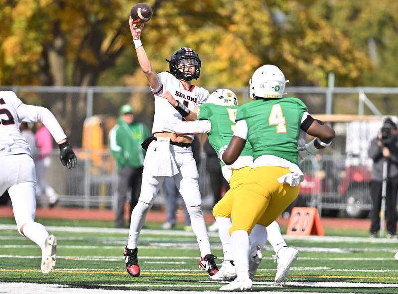 Springfield's Brody Scheffler (1) throws a pass under pressure  during the class 5A first round playoff game against Providence Catholic on Saturday, NOV. 01, 2025, at New Lenox.