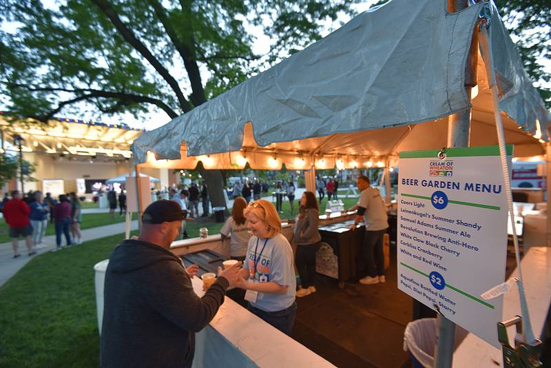 A beer garden displays its menu in Memorial Park at the Cream of Wheaton summer festival in downtown Wheaton on Thursday, May 30, 2024.