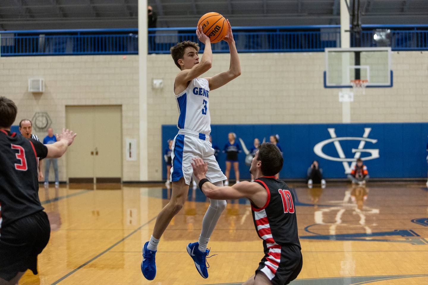 Geneva's Nathan Palmer shots a jumper over Batavia's Joseph Reid  on Friday, Dec.19,2025 in Geneva.