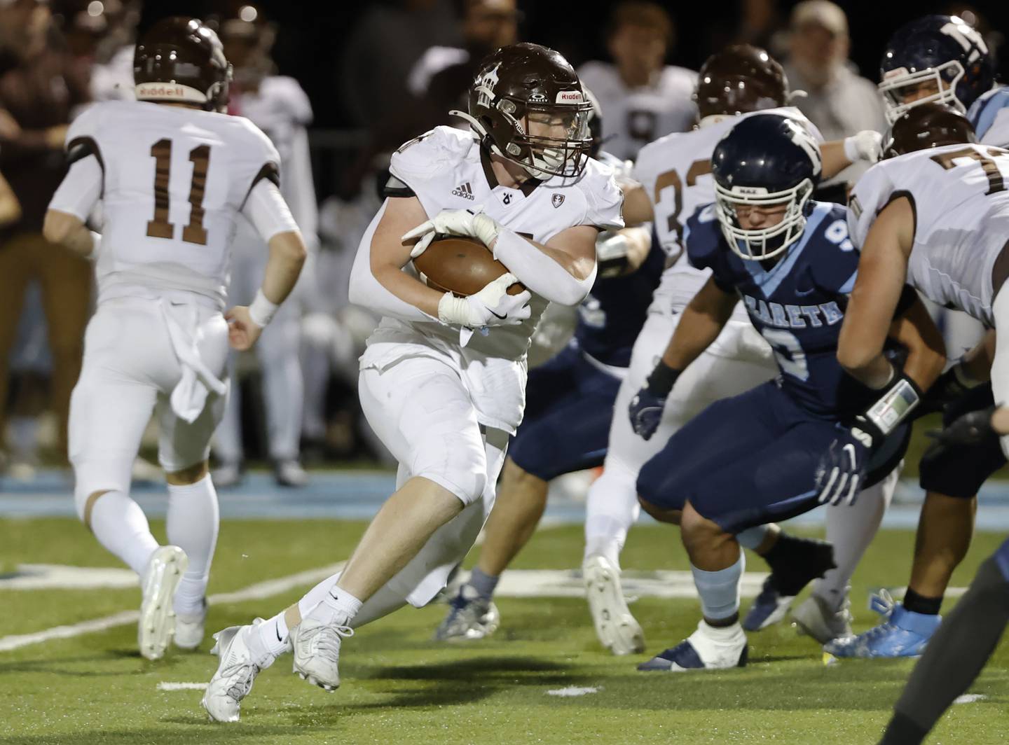Joliet Catholic's Lawrence Stringham (24) carries the ball during the varsity football game between Joliet Catholic and Nazareth academies on Friday, Sep. 27, 2024 in La Grange Park.