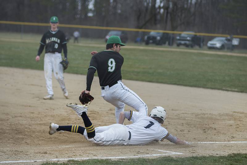 Sterling's Daylen Stage dives in safely at first base to beat out an infield hit Tuesday, April 5, 2022 against Alleman.