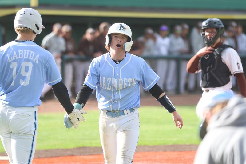 Nazareth’s Gavin Hartigan is greeted by Bobby Labuda after scoring against Joliet Catholic on Wednesday, April 29, 2026 in Joliet.