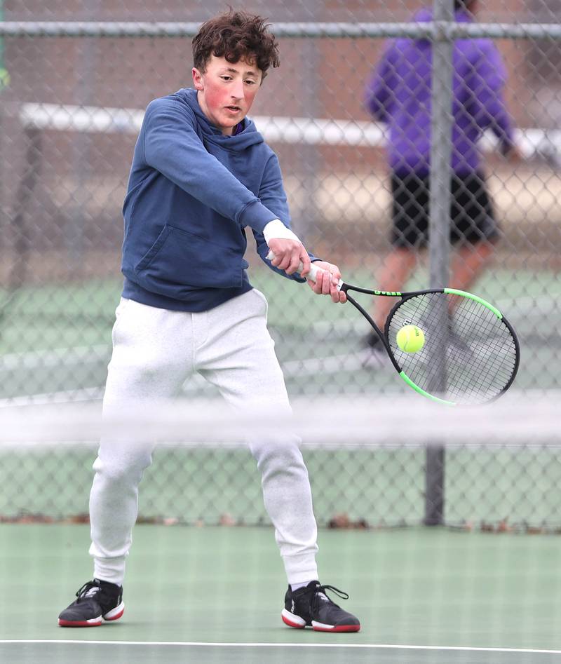 Dixon’s number one singles player Bashar Elbzour hits a backhand during his match against Sycamore Thursday, March 30, 2023, at Sycamore High School.