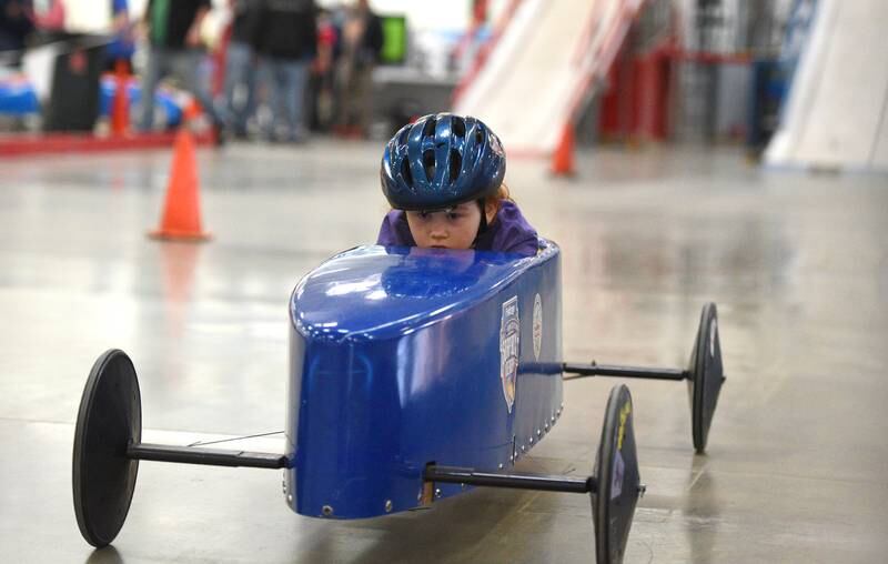 Paityn Thoresen, 8, of Island Lake races down a 200-foot track after coming down an eight-foot ramp during soap box derby races Sunday at the former SamÕs Club location in Batavia. The event was held by Greater Chicago Soap Box Derby, which holds six races a year.