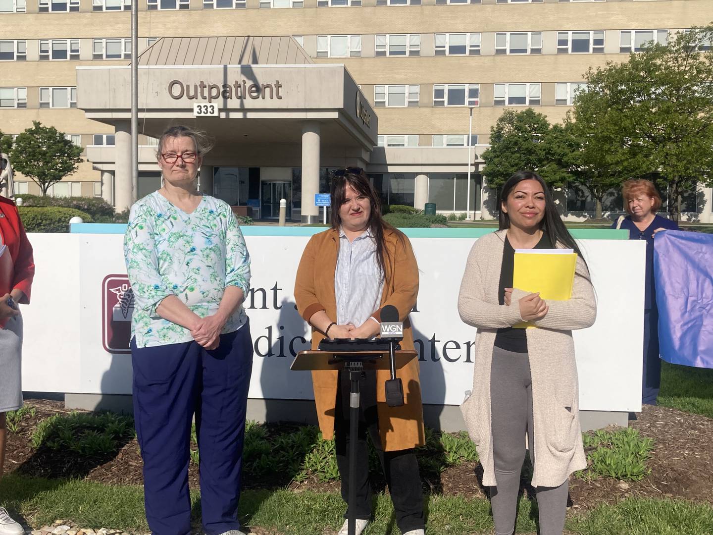 Nurses Kathy Wolff (left) and Amber Velasquez (right) with Illinois Nurses Association Lead Legislative Organizer Margot Gislain take questions at a press event at St. Joseph Medical Center on Monday, May 4, 2026.