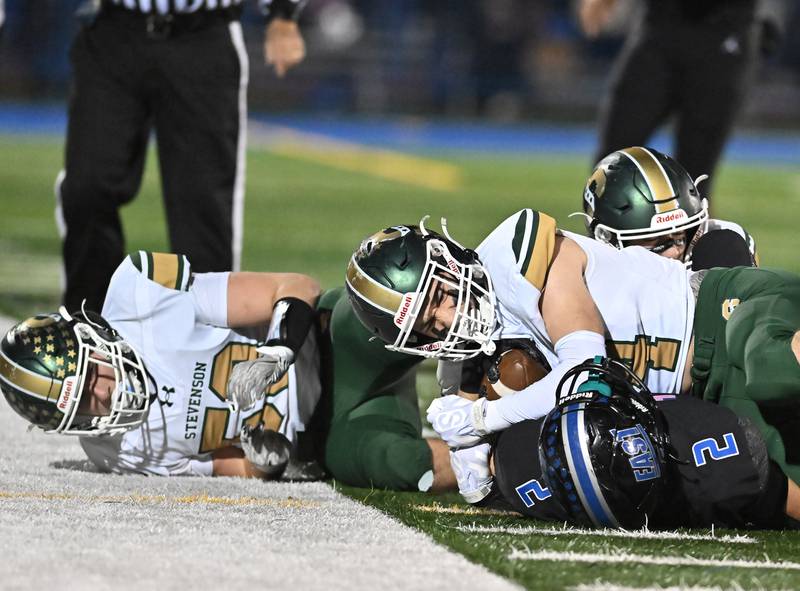 Stevenson's Aiden Elliot (44) tries to strip the ball from Lincoln-Way East's tight end Trey Zvonar (2) during the IHSA Class 8A Quarterfinals game on Friday, Nov. 15, 2024, at Frankfort. (Dean Reid for Shaw Local News)