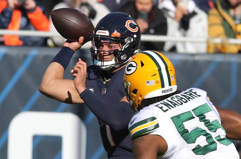Chicago Bears quarterback Justin Fields gets off a pass just ahead of the rush of Green Bay Packers linebacker Kingsley Enagbare during their game Sunday, Dec. 4, 2022, at Soldier Field in Chicago.