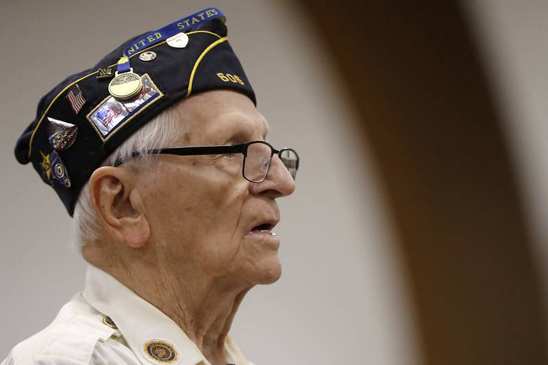 U.S. Navy World War II veteran Walter Eichman stands as the Navy Band Great Lakes performs “Anchors Aweigh” during the Veterans Day ceremony Wednesday, Nov.8, 2023, at Alden-Hebron High School in Hebron.