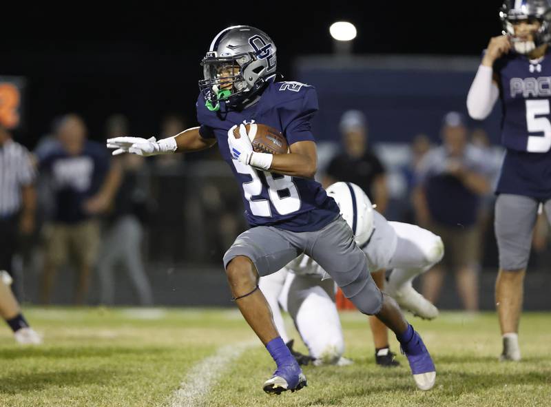 Oswego East's Zamarion Taylor (28) runs the ball during the varsity football game between Plainfield South and Oswego East on Friday, Sep. 20, 2024 in Oswego.