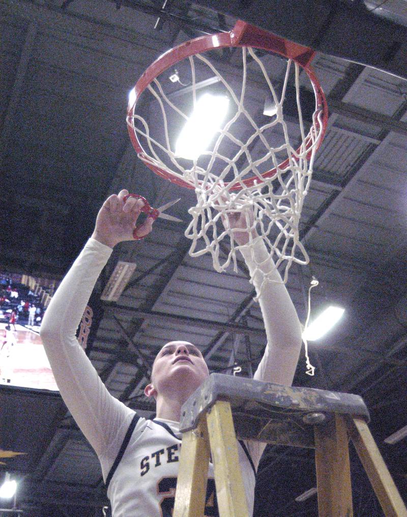 Sterling's Madison Austin cuts a piece of the net. The Sterling Golden Warriors faced off against Plano Lady Reapers in an IHSA 3A Regional girls final at Musgrove Fieldhouse in Sterling on February 20, 2025. Sterling won the game 70-38.