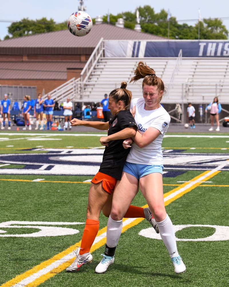 St. Charles East Mia Raschke, left, and St. Charles East Kara Machala goes up to head the ball during the second half of the sectional title game held on Saturday May 27th at West Chicago Community High School.