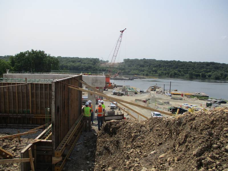 Construction crews work on the Houbolt Road bridge on the north bank of the Des Plaines River in Joliet on Tuesday, July 21, 2021.