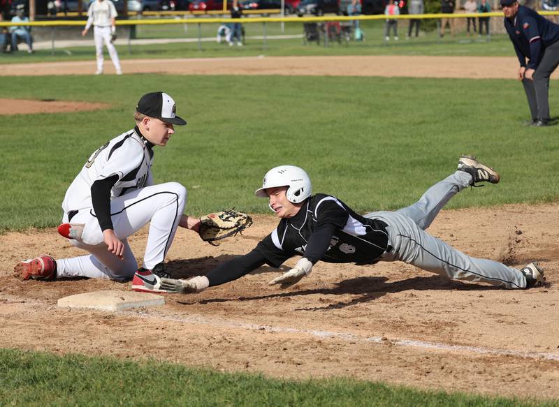 Kaneland's Caleb Cornell gets back just ahead of the tag of Sycamore's Noah Neece on a pickoff attempt Tuesday, April 28, 2026, during their game at the Sycamore Community Sports Complex.