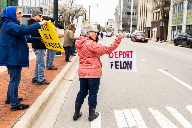 Joliet resident Kathy Mazur holds up a 'Deport F'Elon' sign during the Hands Off protest in Downtown Joliet on April 5, 2025.