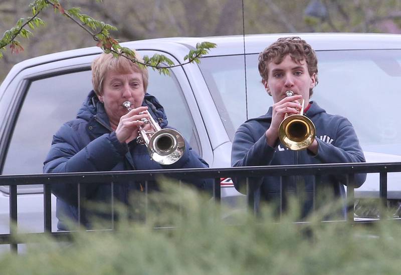 Nancy Stewart of Utica and her grandson Joey Patyk of Tonica, play "taps" on trumpets during the 20th anniversary of the tornado at the memorial on Saturday, April 20, 2024 in Utica.