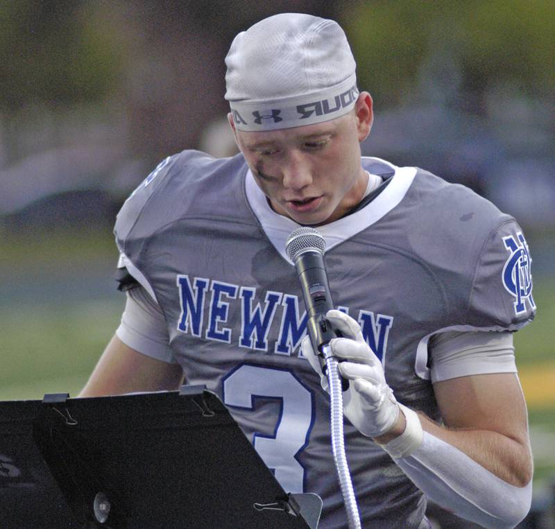 Newman senior George Jungerman leads the crowd in prayer before the football game. Newman Central Catholic H.S hosted Princeton H.S. in a non-conference football game at Sterling H.S, on Friday, August 29, 2025.