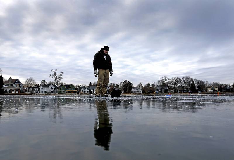David Leach Jr., ice fishes on Wednesday, Jan. 8, 2025, on the westside of Crystal Lake near the Lakewood Village Hall.