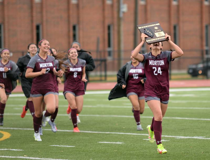Morton's team including Aaliyah Leanos show their winning trophy to their fans during their regional final game against Hinsdale Central  Saturday May 21, 2022.