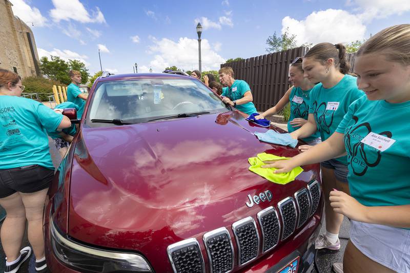 Building Lasting Impressions that Never Die (BLIND) leaders wash and dry a vehicle Friday, Aug. 2, 2024, in Sterling. The group was offering the free wash as a way to benefit the community.