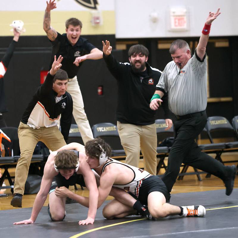 Kaneland coaches celebrate as Alex Gochis wins his match in overtime against Sycamore’s Jayden Dohogne during their 138 pound match Thursday, Jan. 9, 2025, at Sycamore High School.