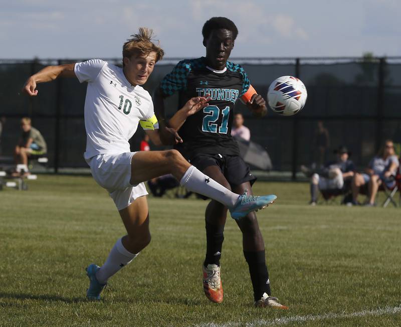 Crystal Lake South's Nolan Getzinger kicks the ball towards the goal as he is defended by Woodstock North's Nii Amoo during a non-conference soccer match Monday, Aug. 22, 2022, between Crystal Lake South and Woodstock North at Woodstock North High School.