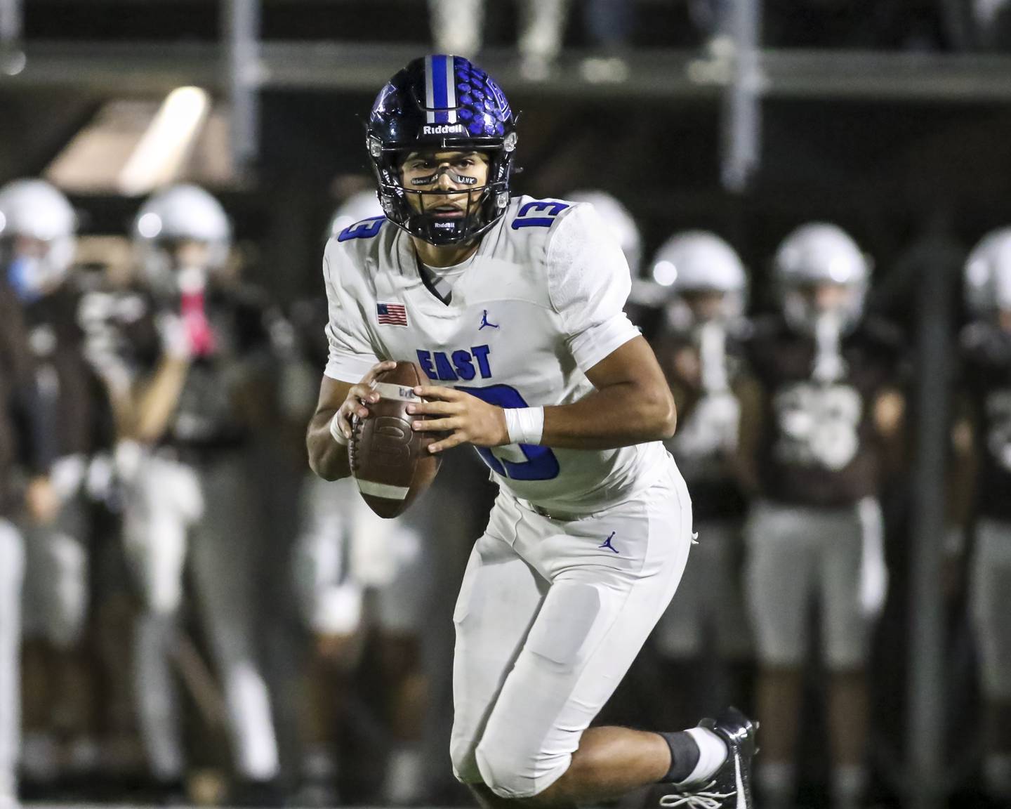 Lincoln-Way East's Jonas Williams (13) rolls out during Class 8A quarterfinal football game between Lincoln-Way East at Mount Carmel. Saturday, Nov 15, 2025 in Chicago.