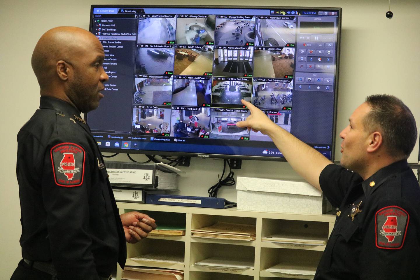 Northern Illinois University Chief of Police Darren Mitchell (left) watches on as Commander Joe Przybyla (right) points to activity on a monitor Thursday, Feb. 9, 2023 at the NIU Department of Police and Public Safety in DeKalb.