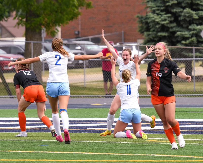 St. Charles North Rian Spaulding, right, reacts with teammates after scoring a goal and tying the game 2-2 during the overtime portion of the sectional title game on Saturday May 27th held at West Chicago Community High School.