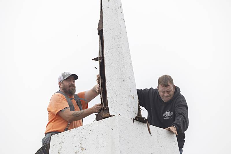 Adam Benford (left) and Keith Persico of Boss Roofing work to separate the steeple from the base Wednesday, Sept. 13, 2023. Goodfellows of Lee County bought the building in January of 2022.