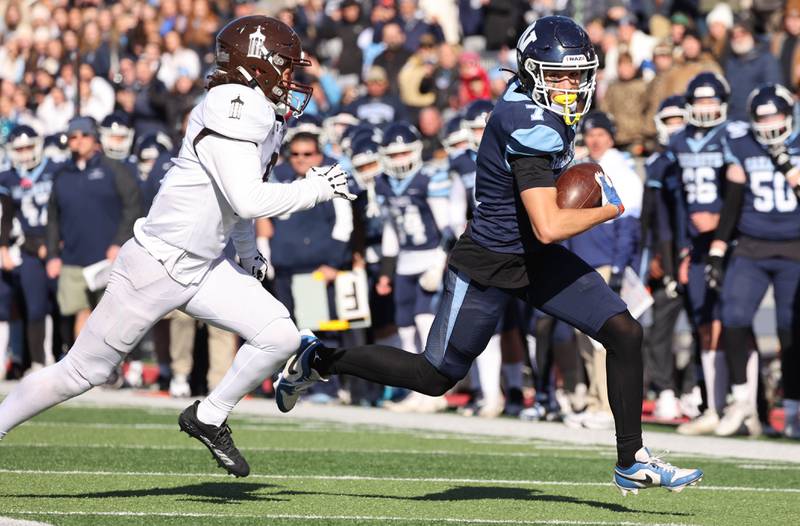 Nazareth's Jake Cestone outruns Joliet Catholic's Tai Sesta to the endzone after a catch Saturday, Nov. 25, 2023, during their IHSA Class 5A state championship game in Hancock Stadium at Illinois State University in Normal.