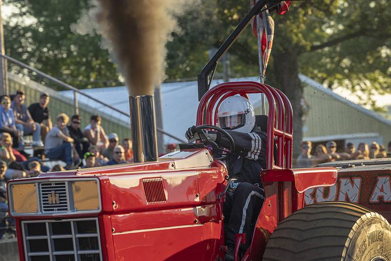 Brent Lenorud grips the wheel as he drags the sled down the track Wednesday, Aug. 7, 2024, at the Carroll County Fair.