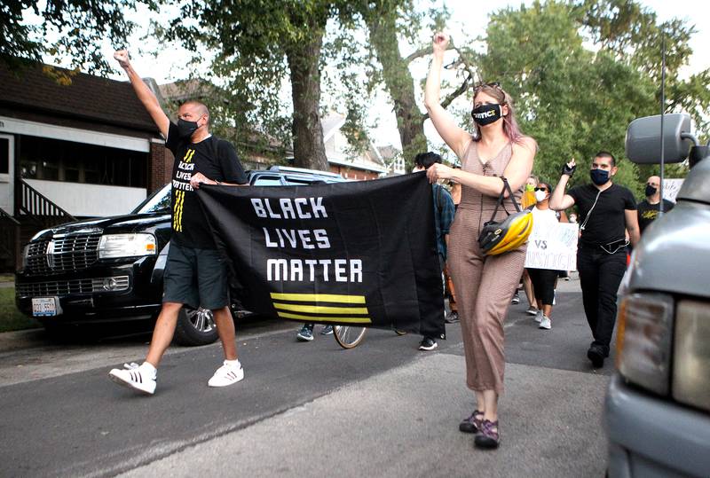 Benjamin Henning (left) leads a short march around the block followed a Black Lives Matter rally and celebration of diversity outside Berwyn's City Hall on Aug. 11.