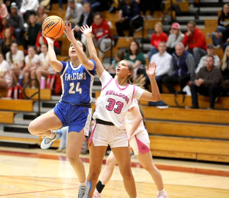 Wheaton North’s Sara Abdul gets a shot up past Batavia’s Natalie Warner (right) during a game on Wednesday, Jan. 29, 2025 at Batavia.