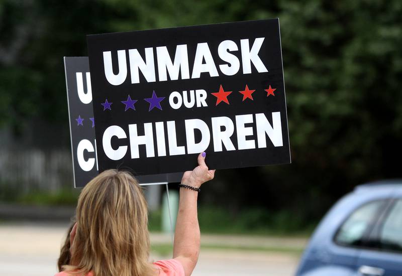 Parents gathered outside Thompson Middle School in St. Charles on Monday, Aug. 9 to voice their opinions to have the St. Charles District 303 School Board vote for parental choice when it comes to students wearing masks in school this fall.