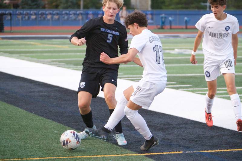 St. Charles North's Jacop Piper battles for the ball with Geneva's Ben Raby on Tuesday, Sept. 9,2025 in St. Charles.