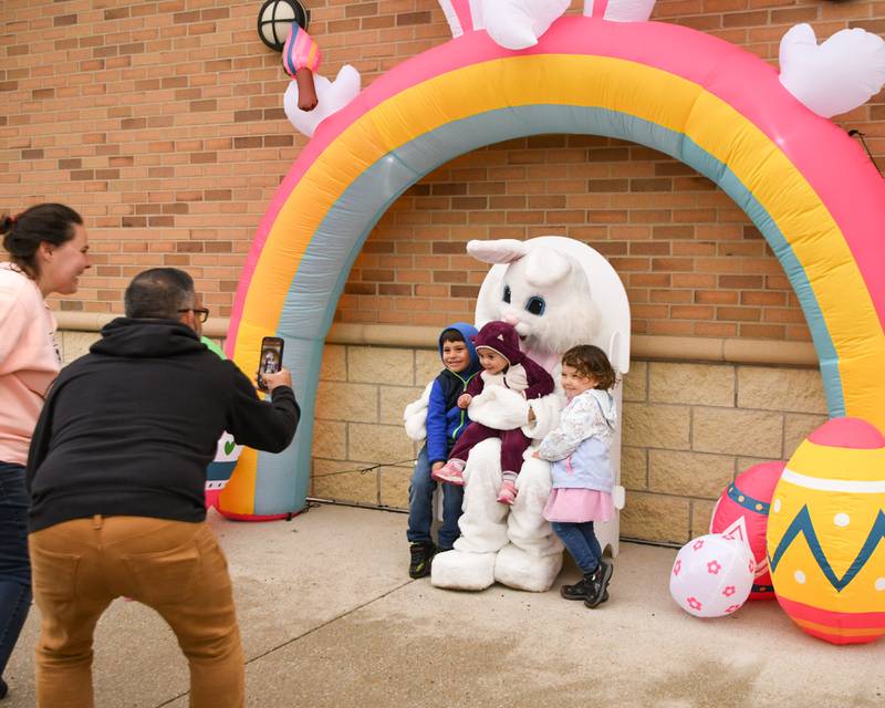 Christian and Daria Vasquez of Elmhurst tried to get photos of their kids Christian Vasquez II, 5, Andrea, 1, and Daria Rose with the easter bunny during the Easter egg hunt on Saturday April 19, 2025, held at Berens Park in Elmhurst.