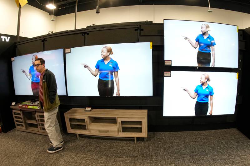 FILE - A customer turns away after looking at big-screen televisions on display in a Best Buy store, Nov. 21, 2023, in southeast Denver. (AP Photo/David Zalubowski, file)