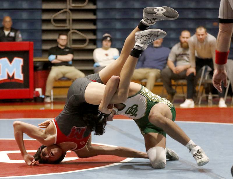 Marian Central's Nicolas Davidson hits the matt as he tries to get out of the grasp of St. Patrick's Nikolas Karamaniolas in their 138-pound wrestling match Thursday, Jan. 19, 2023, at Marian Central High School in Woodstock.