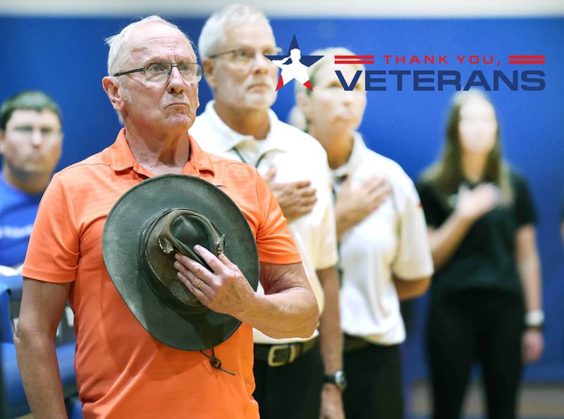 United States Navy Veteran Jim Kush stands during the National Anthem Tuesday, Sept. 5, 2023, at Genoa-Kingston High School before fulfilling his duties as official score keeper for the Genoa-Kingston volleyball team. Kush has also sang the National Anthem at Genoa-Kingston sporting events.