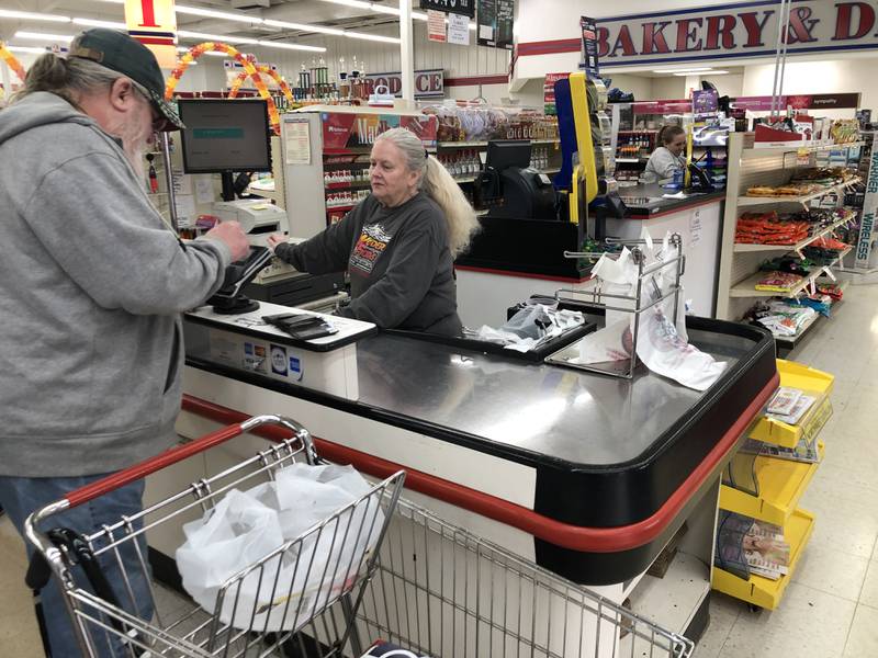 Clerk Jeannie Gebbia, who has worked at Wonder Lake's Wonder Foods for three years, checks on customer Joe Poulus on Sunday, Oct. 16, 2022. Store management announced this week it is closing.