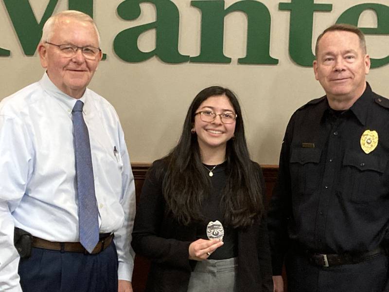 Angellynn Hurtado is flanked by Manteno Mayor Tim Nugent, left, and Chief of Police Alan Swinford after being sworn in as a police officer on Monday at the village board meeting.