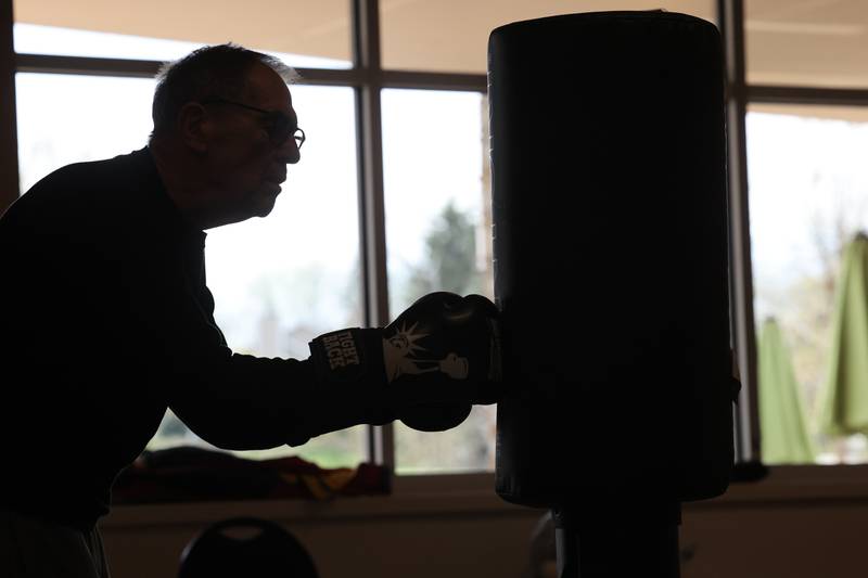 Peter Schram hits the bag Friday, April 28, 2023, during Rock Steady Boxing for Parkinson's Disease class at Northwestern Medicine Kishwaukee Health & Wellness Center in DeKalb. The class helps people with Parkinson’s Disease maintain their strength, agility and balance.