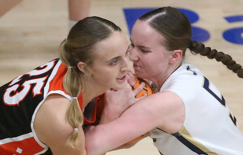 Roanoke-Benson's Callie Kennell and Marquette's Chloe Larson go after a jump ball on Thursday, Feb. 6, 2025 in Bader Gym at Marquette High School.