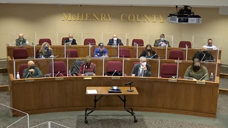 McHenry County Board members listen to comments made before the vote was taken to approve Democrat John Collins to the board to replace Suzanne Ness in serving the residents of District 2.