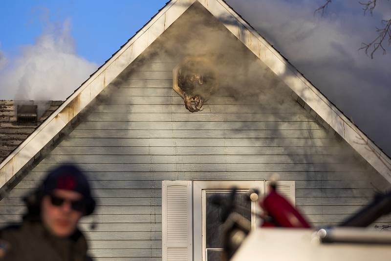Smoke billows from the attic of a house Sunday, Jan. 19, 2025, in Emerson.