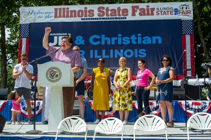 Gov. JB Pritzker addresses the crowd and receives cheers from his fellow party leaders at a Governor’s Day rally Wednesday, Aug. 13, at the Illinois State Fair in Springfield.