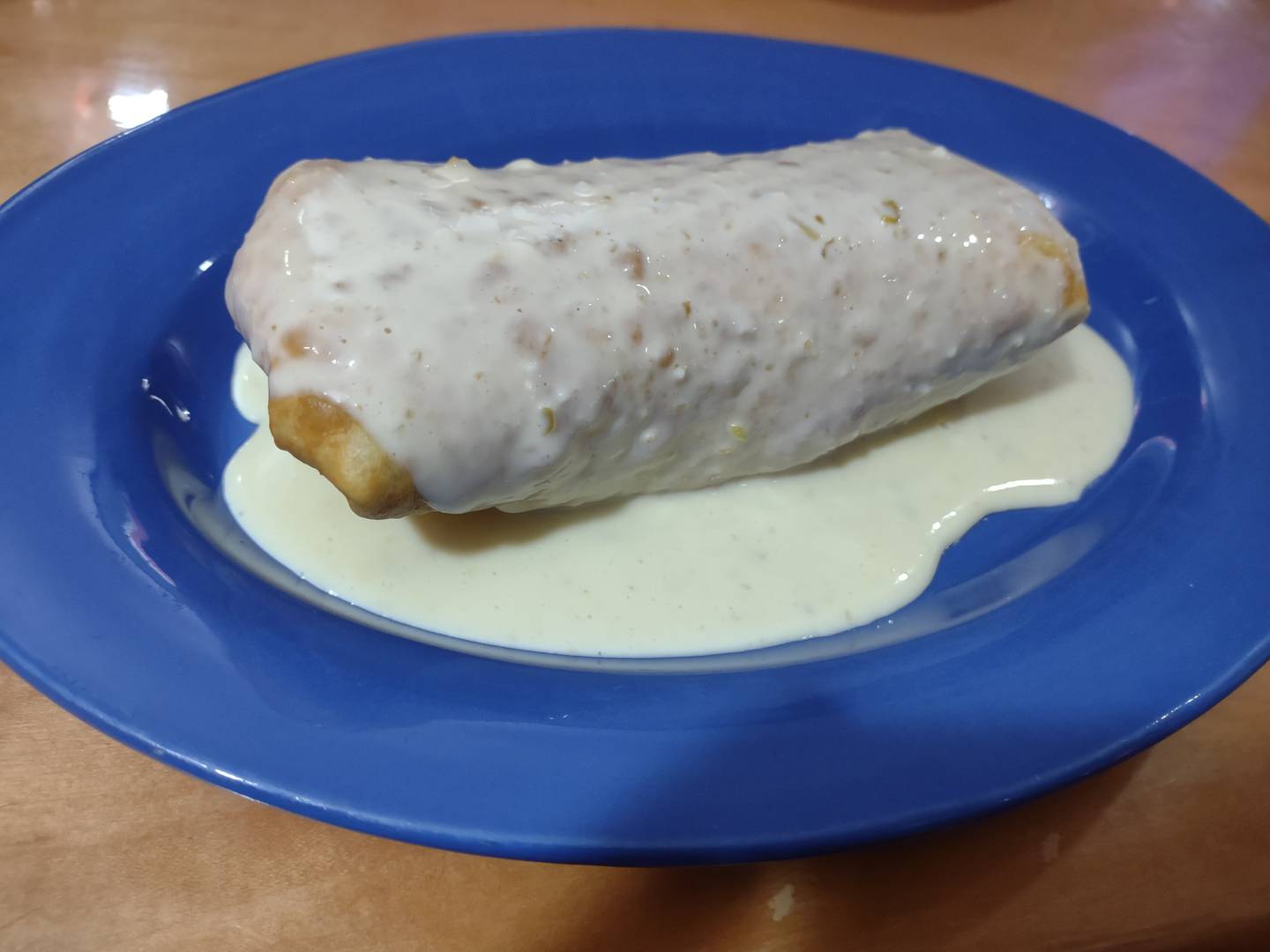 A ground beef chimichanga covered in cheese sauce from La Casa Jalisco in Streator.